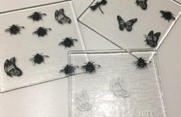 Black and white screen prints on glass coasters