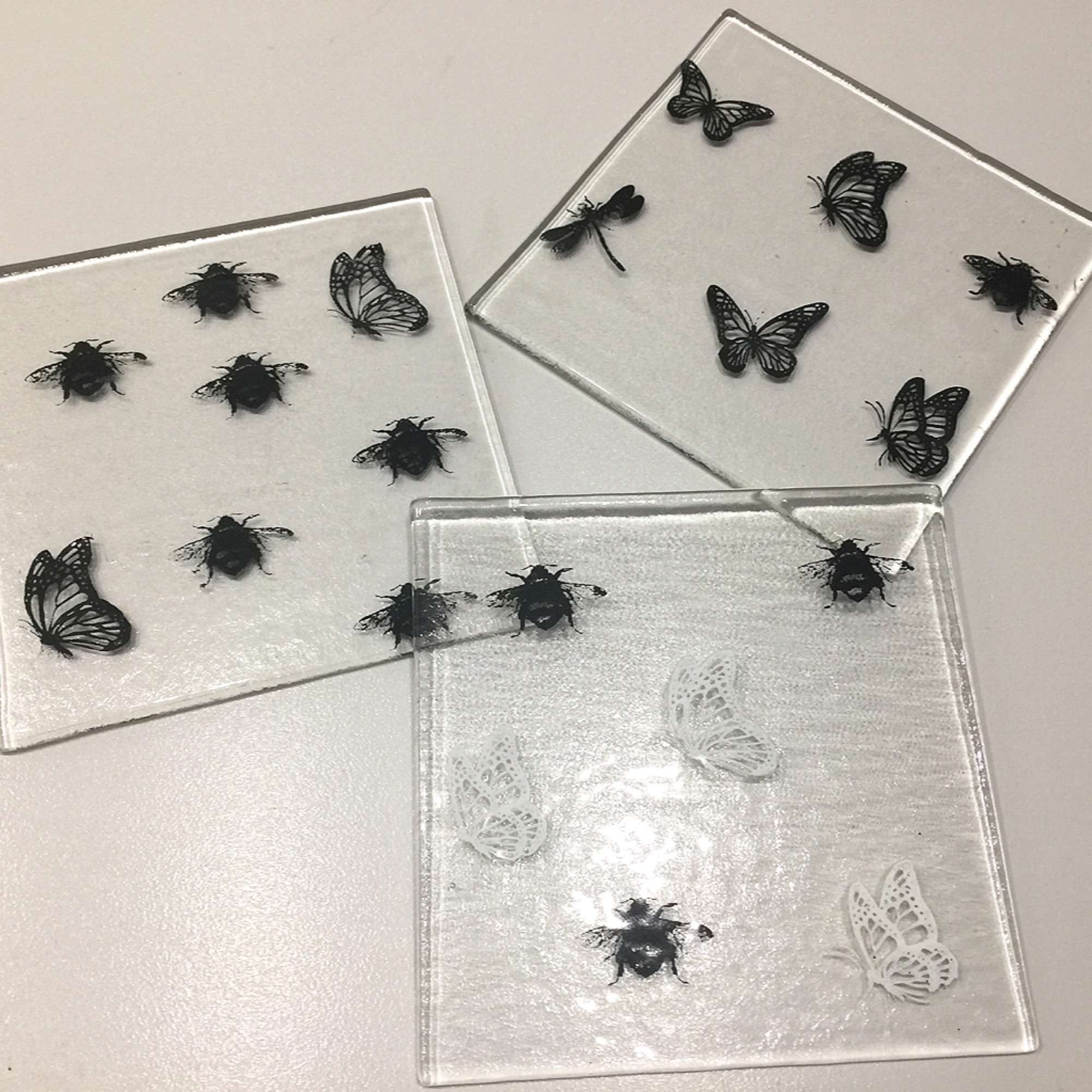 Black and white screen prints on glass coasters