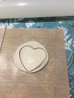 Silver clay cut into heart form ready to be fired