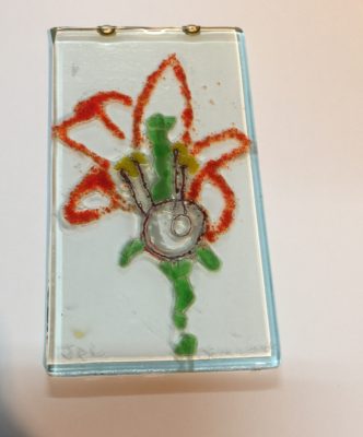 Lily flower in red glass outline, green stem with copper wire detailing